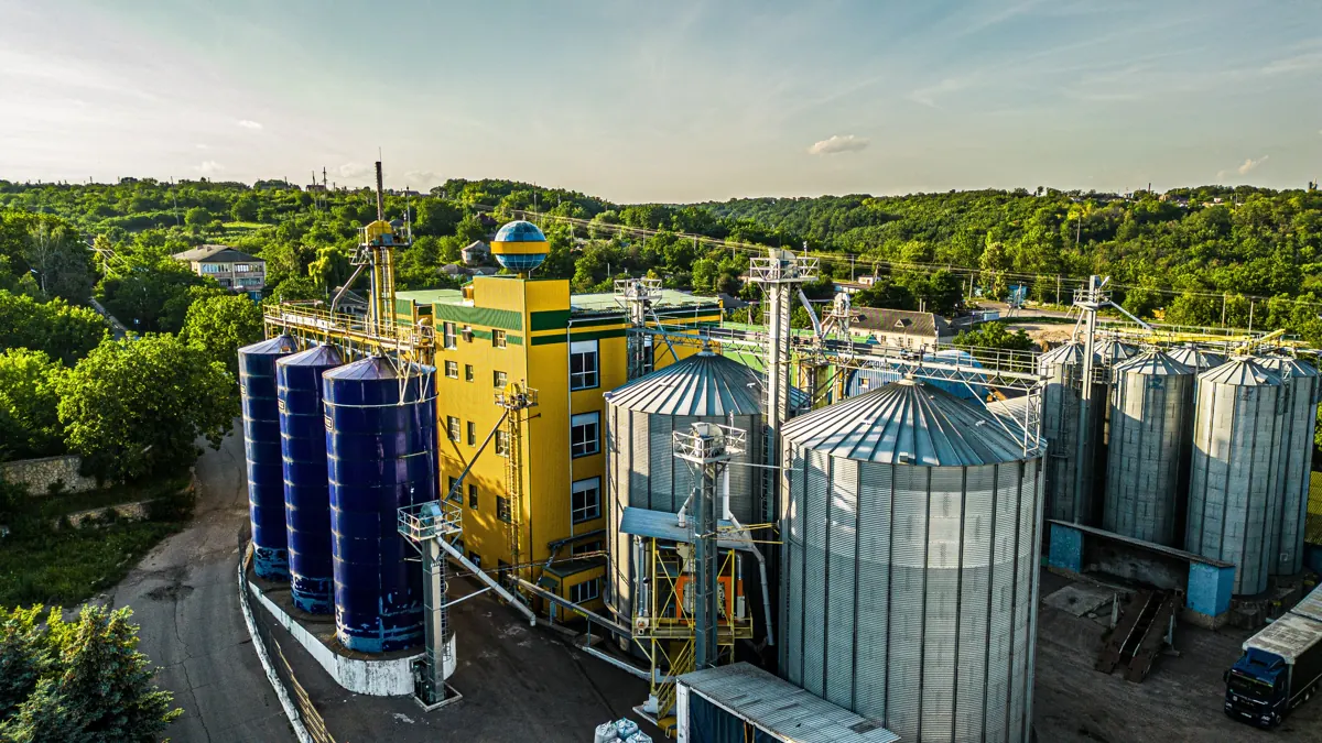 Raw-seed silos, production building and finished-goods warehouse